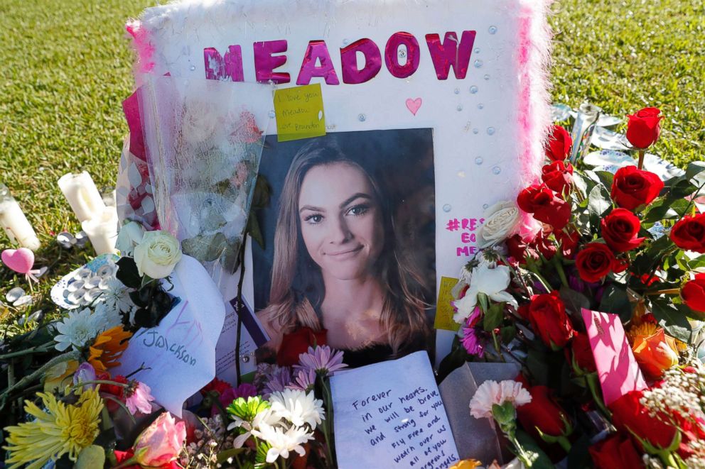 A photo of Meadow Pollack, one of the seventeen victims who was killed in the shooting at Marjory Stoneman Douglas High School, sits against a cross as part of a public memorial, in Parkland, Fla., Feb. 17, 2018.