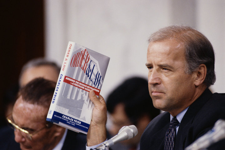 Joe Biden, then chairman of the Senate Judiciary Committee, holds up the book <i>Order and Law</i> by Charles Fried during th