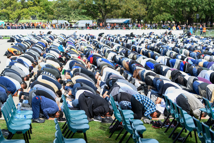 Members of the Muslim community participate in Friday prayers at Hagley Park, near Al Noor mosque, on March 22, 2019 in Chris