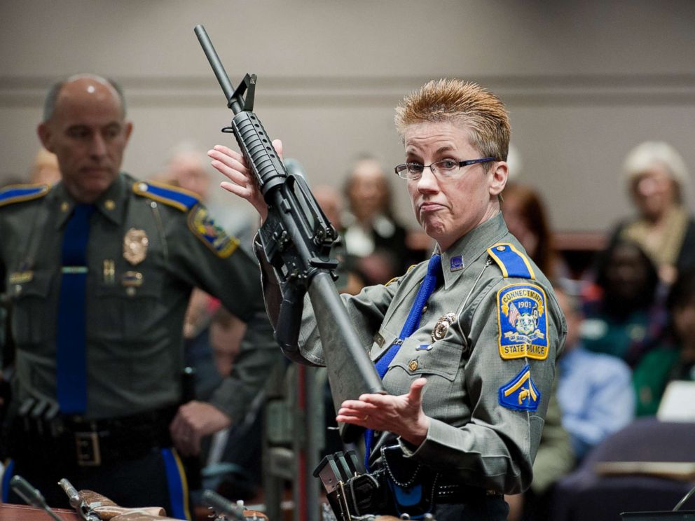 PHOTO: A Connecticut State Police officer holds up a Bushmaster AR-15-style rifle, the same make and model of gun used by Adam Lanza in the Sandy Hook School shooting at the Legislative Office Building in Hartford, Conn., Jan. 28, 2013.