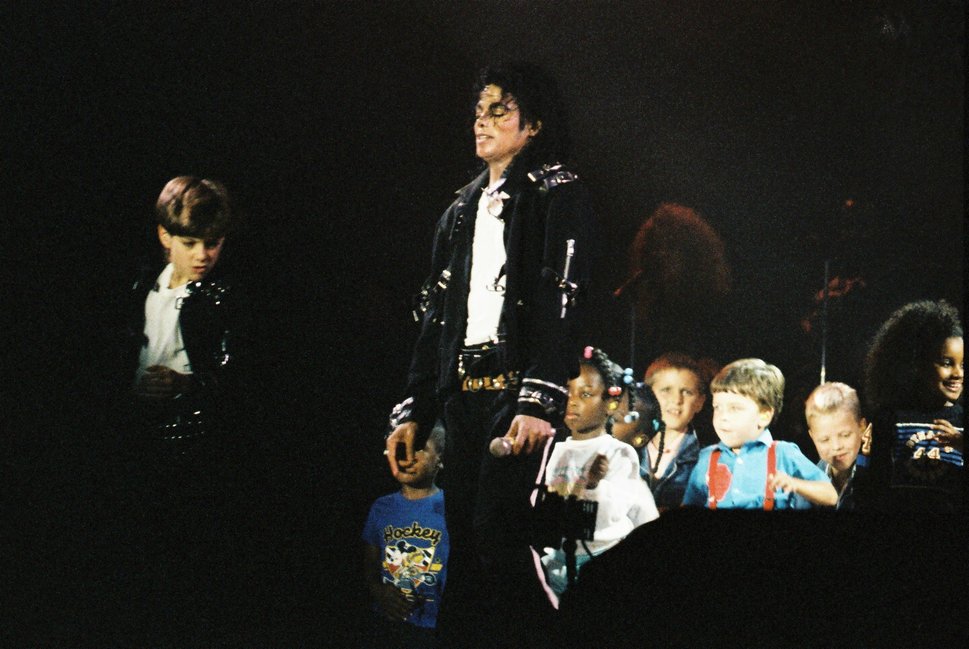 Michael Jackson performing with children during his 1988 "Bad" tour.