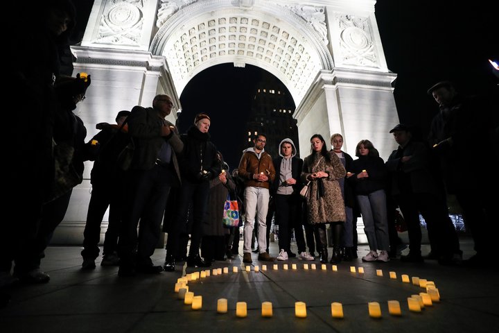 People gather at Washington Square Park in New York during a March 16 vigil held for victims who lost their lives during the 