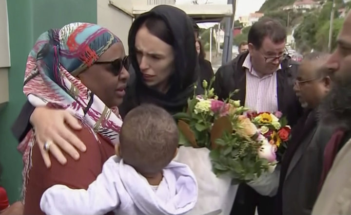 In this image made from video, New Zealand's Prime Minister Jacinda Ardern, center, hugs and consoles a woman as she visited 