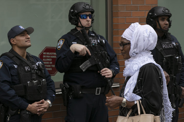 A woman leaves the Islamic Cultural Center of New York under increased police security following the shooting in New Zealand 