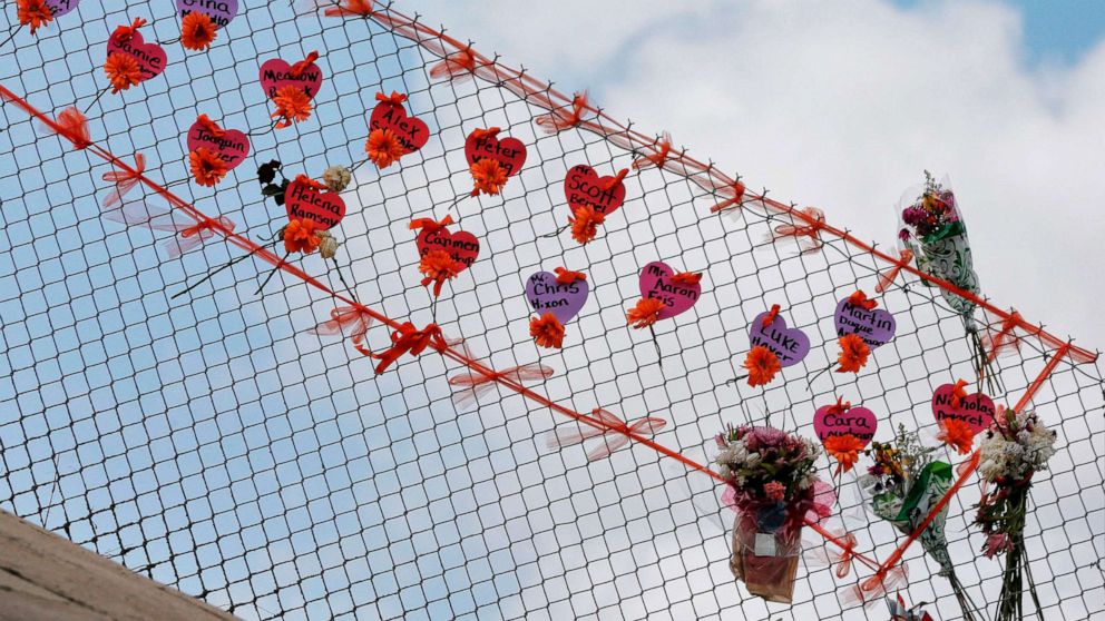 Memorials are seen on a fence surrounding Marjory Stoneman Douglas High School in Parkland, Florida on Feb. 21, 2018.