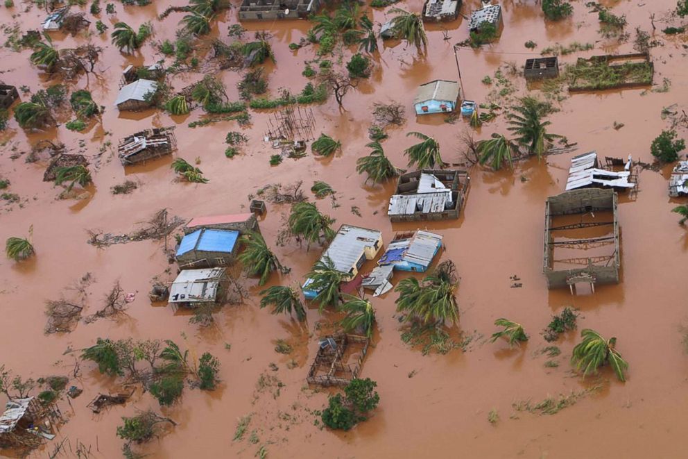 A picture shows houses in a flooded area of Buzi, central Mozambique, March 20, 2019, after the passage of cyclone Idai. International aid agencies raced to rescue survivors and meet humanitarian needs in three impoverished countries battered by one of the worst storms to hit southern Africa in decades.