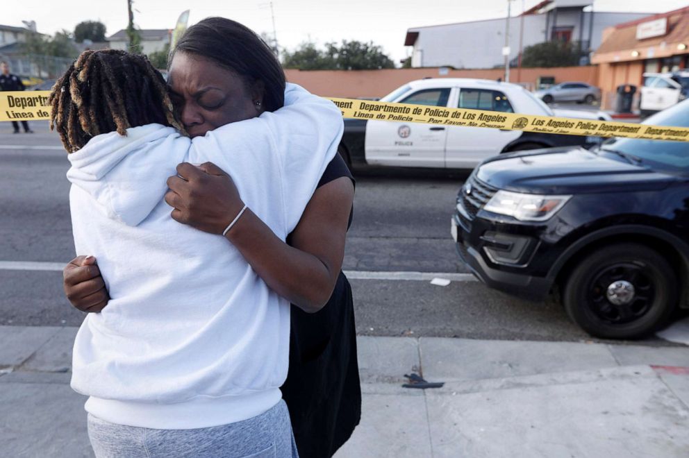 "I'm telling you, that was my friend. My friend's dead. He was my childhood friend," said Marquesa Lawson, 34, left, over the shooting of rapper Nipsey Hussle who was killed in a shooting outside his store, March 31, 2019 in Los Angeles.