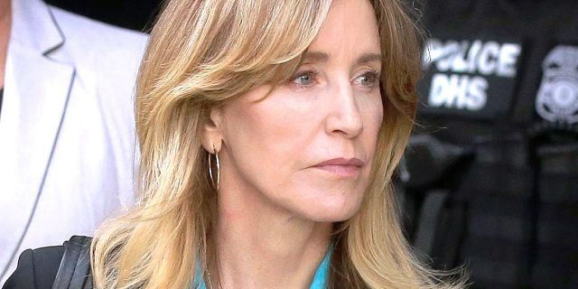 FILE - In this April 3, 2019 file photo, actress Felicity Huffman arrives at federal court in Boston to face charges in a nationwide college admissions bribery scandal. In a court filing on Monday, April 8, 2019, Huffman agreed to plead guilty in the cheating scam. (AP Photo/Steven Senne, File)