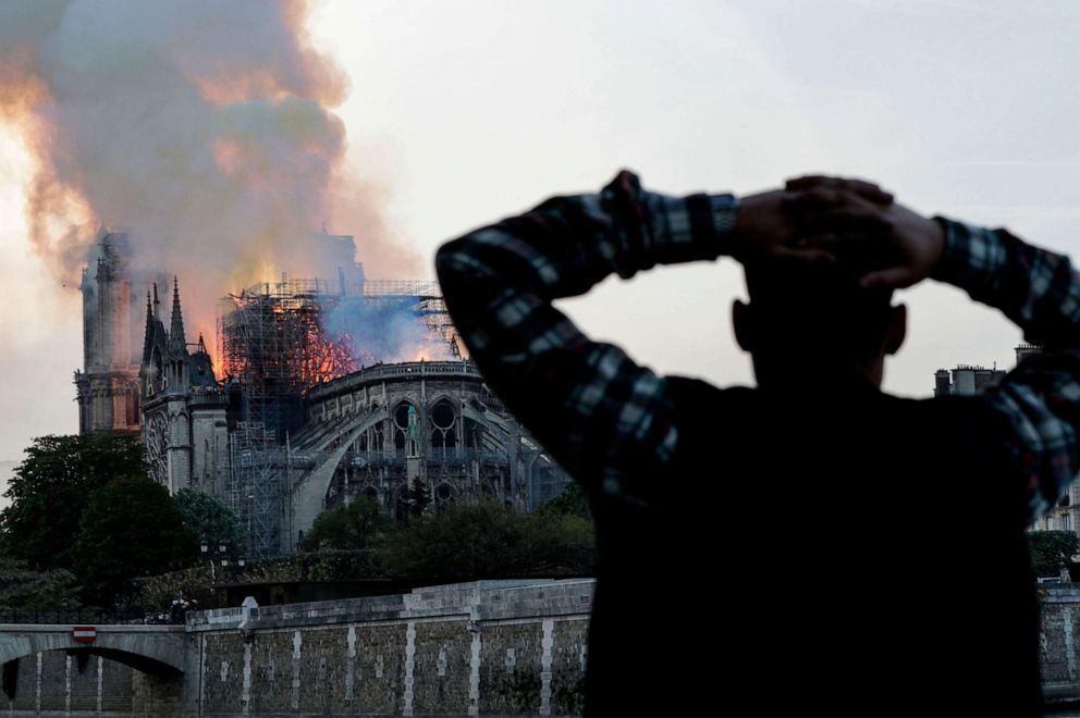 A man watches Notre-Dame Cathedral burn in Paris, April 15, 2019.