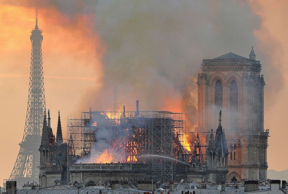 Flames and smoke rise from the blaze after the spire toppled over on Notre Dame cathedral in Paris, April 15, 2019.