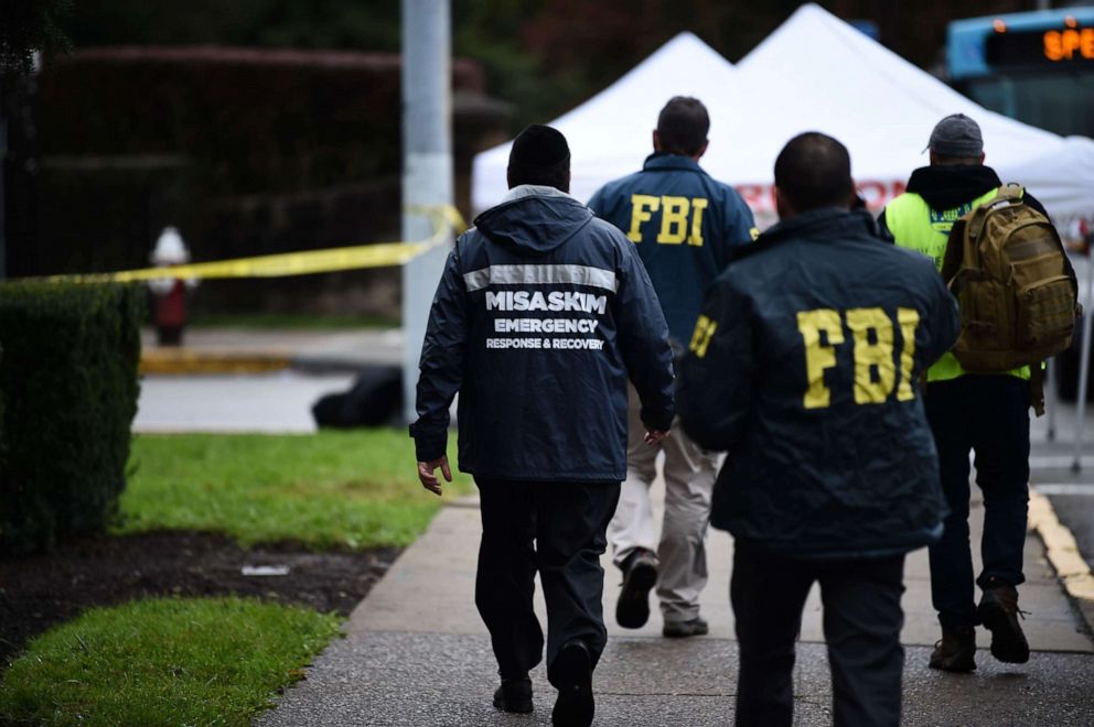 Members of the FBI and others survey the area, Oct. 28, 2018, outside the Tree of Life Synagogue after a fatal shooting in Pittsburgh.