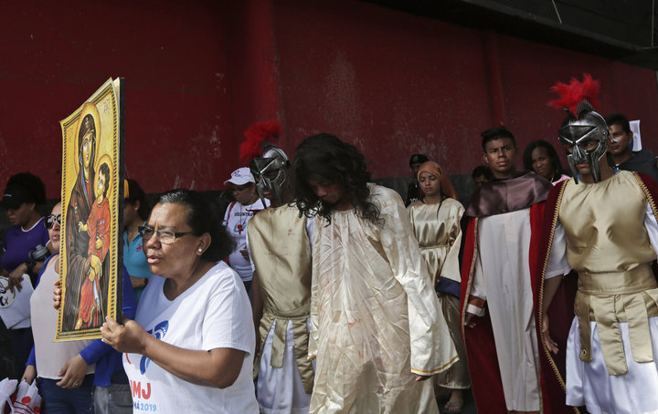 Jose Fuentes, center, portrays Jesus Christ during a Good Friday procession in Panama City on April 19, 2019.