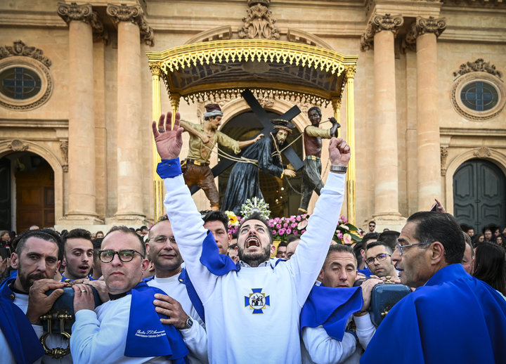 Christians participate in a Good Friday procession in front of the Basilica of the Santissima Annunziata on April 19, 2019 in