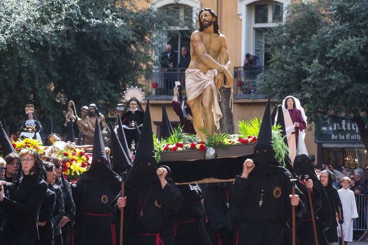A group of penitents takes part in a traditional Catalan Good Friday procession in the center of Perpignan, southwestern Fran