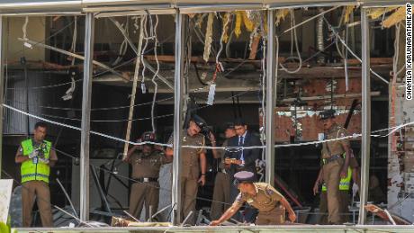 A Sri Lankan officer inspects a blast site at the Shangri-La hotel in Colombo.