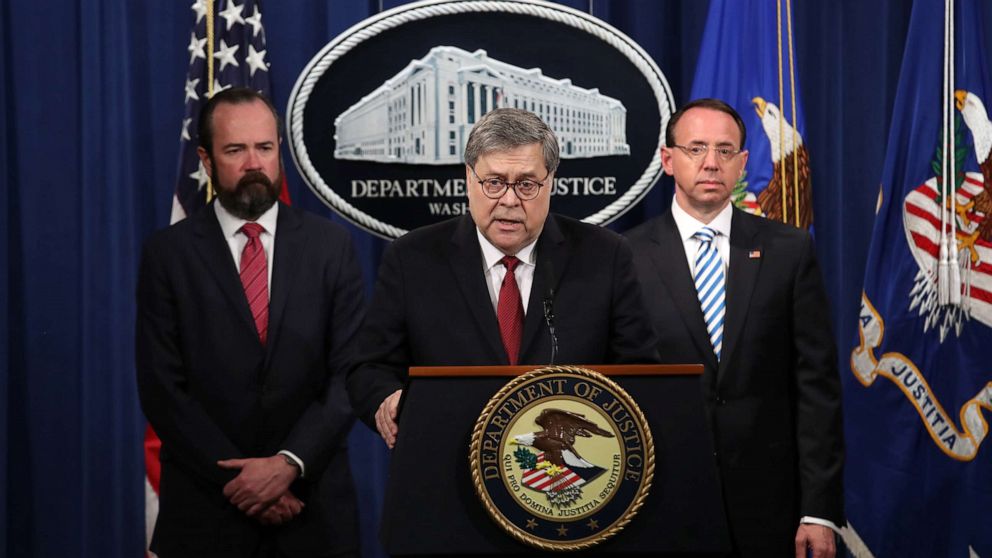 U.S. Attorney General William Barr speaks about the release of the redacted version of the Mueller report as U.S. Deputy Attorney General Rod Rosenstein, right, and U.S. Acting Principal Associate Deputy Attorney General Ed OCallaghan listen at the Department of Justice, April 18, 2019, in Washington, D.C.
