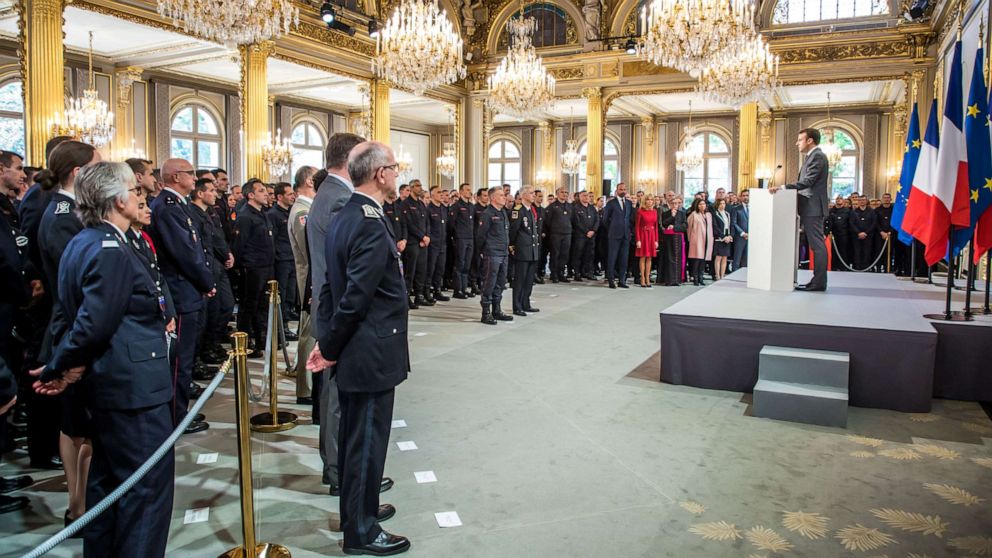 French President Emmanuel Macron delivers a speech for the Parisian Firefighters' brigade and security forces who took part at the fire extinguishing operations during the Notre Dame of Paris Cathedral fire, at Elysee Palace in Paris, April 18, 2019.