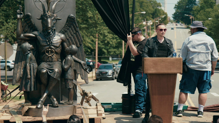 Satanic Temple co-founder Lucien Greaves delivers a speech in front of the Arkansas Capitol, with the group's Baphomet statue