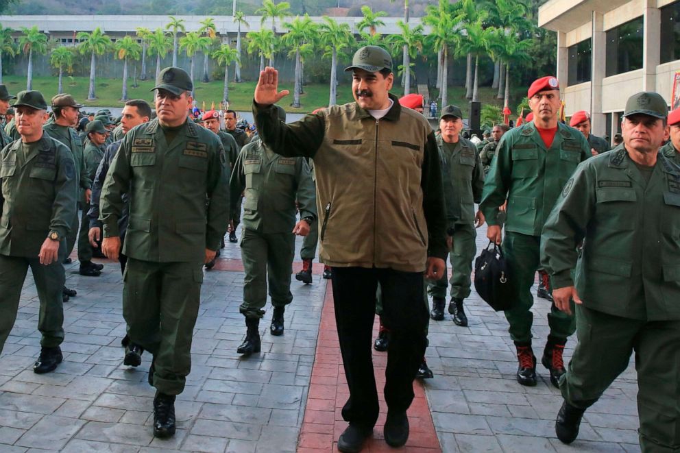 PHOTO: Venezuelas President Nicolas Maduro, center, greets military troops accompanied by Defense Minister Vladimir Padrino, left, at the Fuerte Tiuna in Caracas, Venezuela, May 2, 2019, in a photo released by the Miraflores Palace press office.