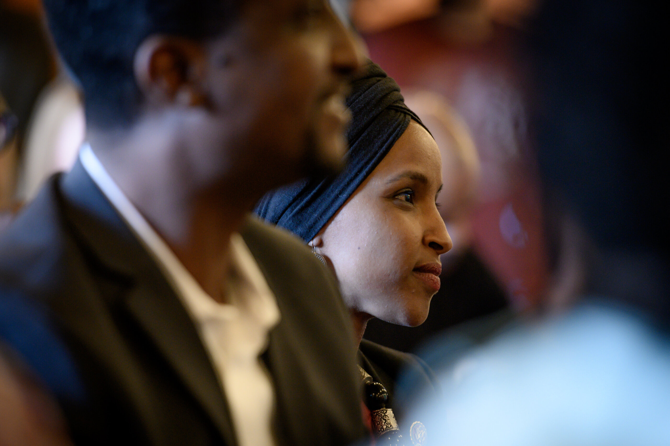 Omar listens to a speaker during the Paycheck Fairness and Women's Workforce Development Town Hall in Minneapolis.