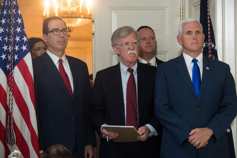 PHOTO: National Security Advisor John Bolton stands with Treasury Secretary Steven Mnuchin and Vice President Mike Pence as they listen to President Donald Trump at the White House, May 8, 2018.