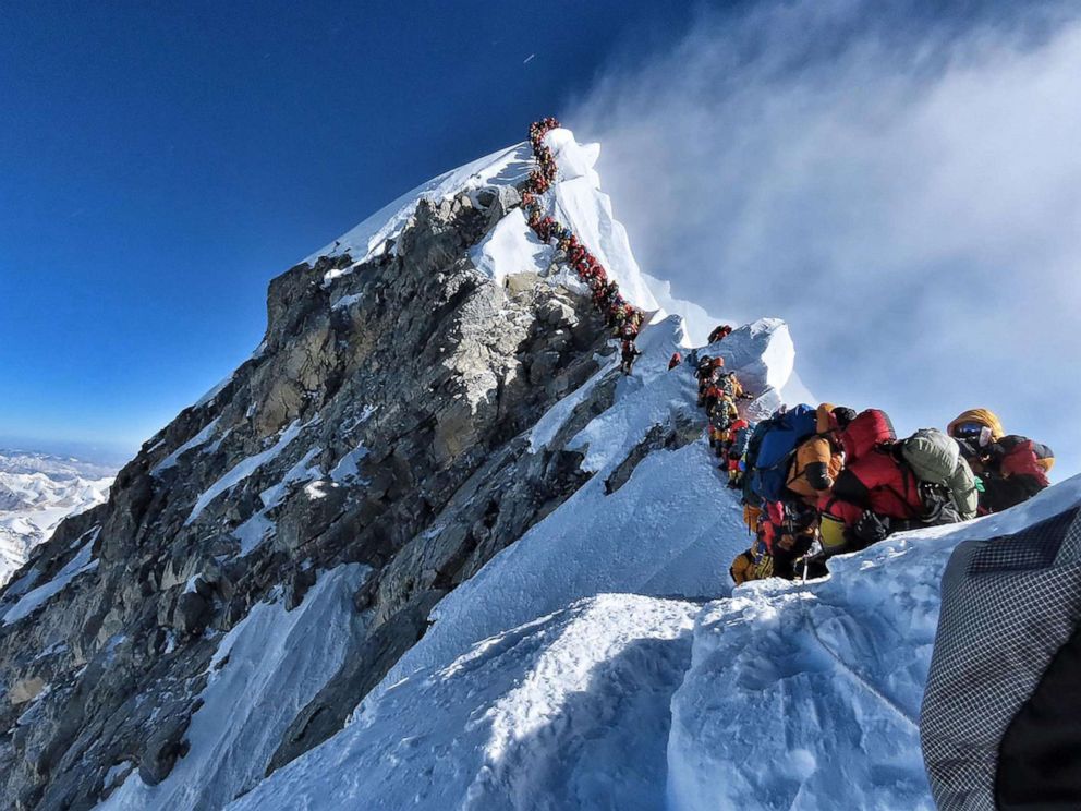 PHOTO: This handout photo taken on May 22, 2019 and released by climber Nirmal Purjas Project Possible expedition shows heavy traffic of mountain climbers lining up to stand at the summit of Mount Everest.