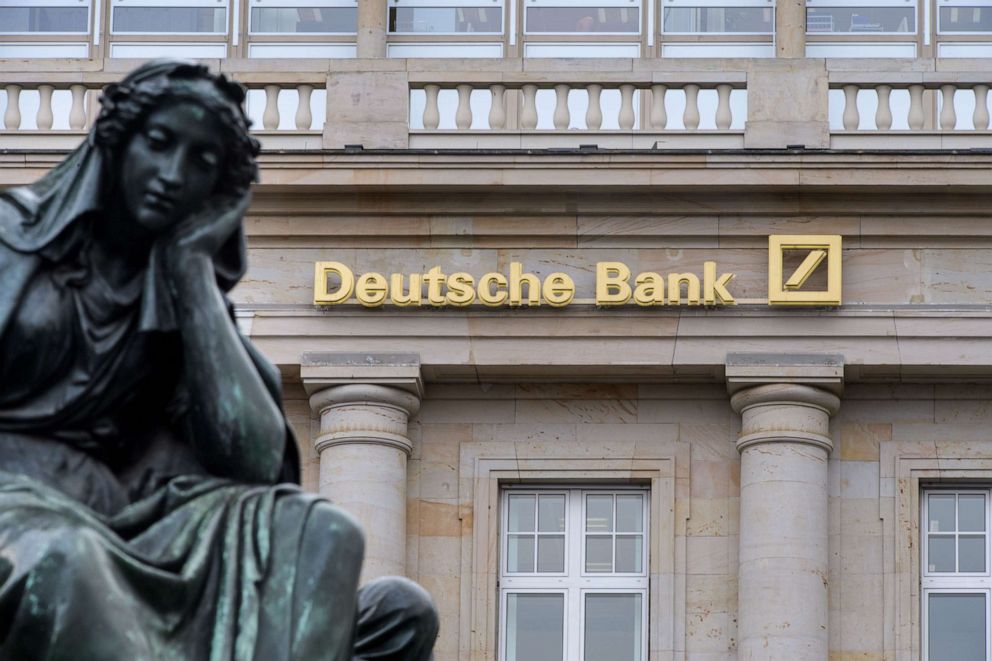 PHOTO: A branch of the German bank Deutsche Bank pictured with a sculpture of the Gutenberg monument, Feb. 1, 2018, in Frankfurt, Germany.