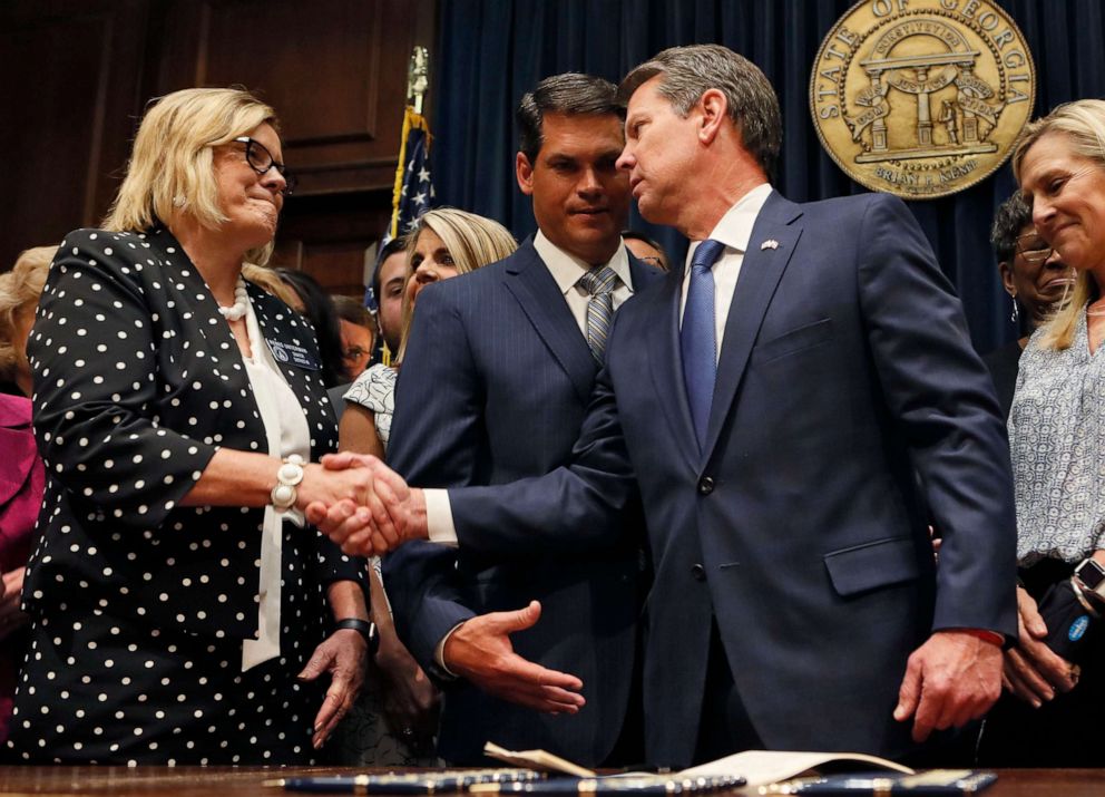 PHOTO: Georgia Gov. Brian Kemp shakes hands with state Sen. Renee Unterman after signing legislation banning abortions once a fetal heartbeat can be detected, in Atlanta, May 7, 2019.