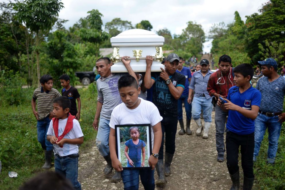 PHOTO:A boy carries a picture of Guatemalan seven-year-old Jakelin Caal in a remote stretch of the New Mexico desert in Guatemala City, Dec. 25, 2018. 