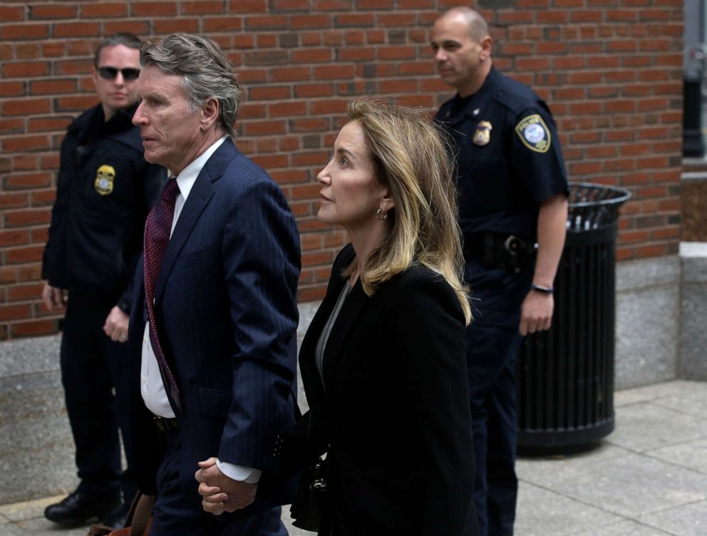 PHOTO: Felicity Huffman arrives with her brother Moore Huffman Jr., at federal court, May 13, 2019, in Boston, where she is scheduled to plead guilty to charges in a nationwide college admissions bribery scandal.