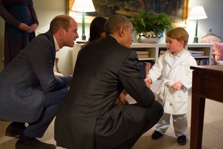 President Barack Obama, Prince William and First Lady Michelle Obama talk with Prince George at Kensington Palace on April 22