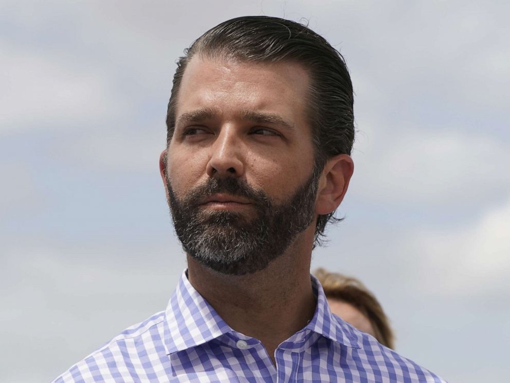 PHOTO: Donald Trump Jr. listens to his father, President Donald Trump, speak during a visit to Lake Okechobee and the Herbert Hoover Dike in Canal Point, Fla., March 29, 2019.