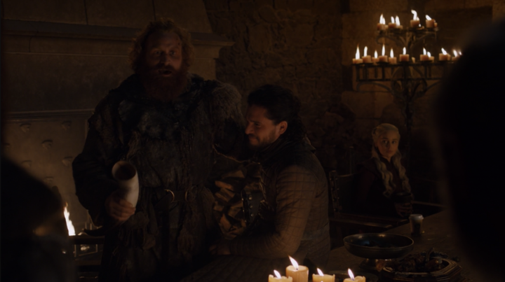 The cup can be seen at the bottom right of the photo, on the table in front of Dany.