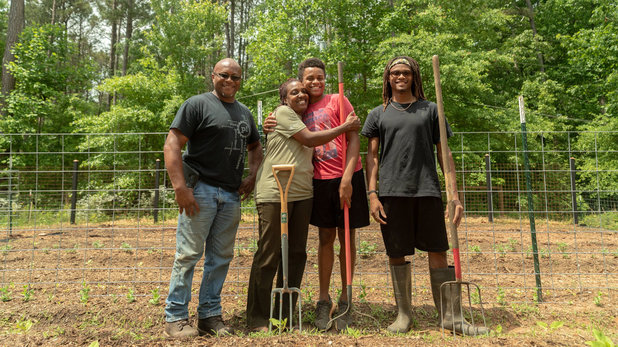 (L-R) Warren Cameron (husband), Keisha, and children Zachary and Abraham. The family owns High Hog Farm in Grayson, Georgia.