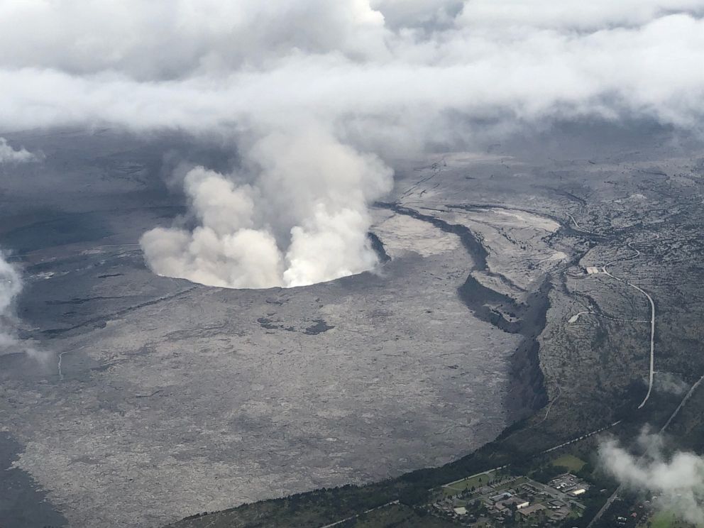 PHOTO: An aerial view of Kilauea Volcanos summit caldera and an ash plume billowing from Halemaumau, a crater within the caldera, in Hawaii, May 27, 2018.