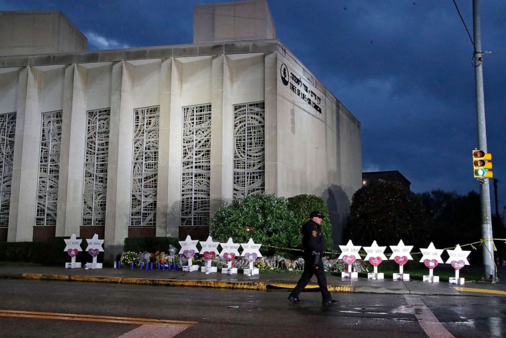 PHOTO: A Pittsburgh Police officer walks past the Tree of Life Synagogue and a makeshift memorial in Pittsburgh, Oct. 28, 2018, in remembrance of those killed and injured when a shooter opened fire during services at the synagogue.