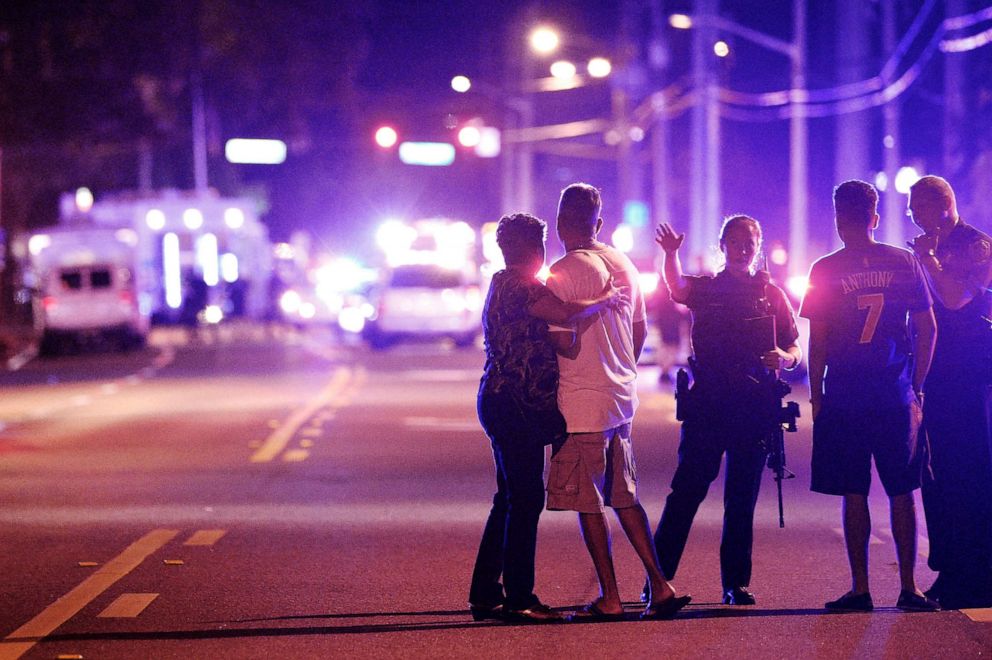 PHOTO: An Orlando Police officer directs family members away from a mass shooting at the Pulse nightclub in Orlando, Fla., that left 49 people dead, June 12, 2016.