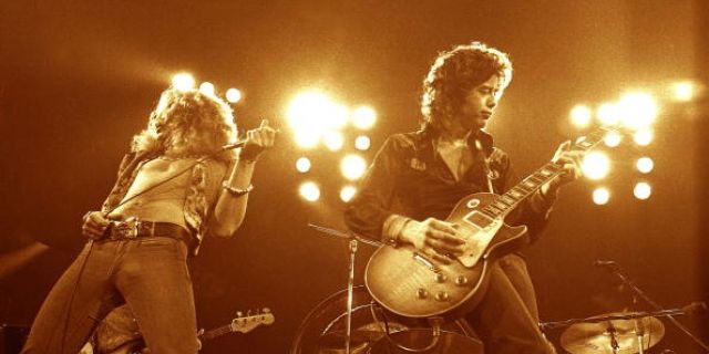 Robert Plant, left, and Jimmy Page performing live onstage (Photo by Robert Knight Archive/Redferns)