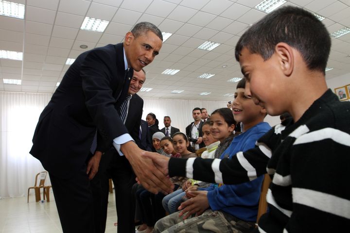 Obama shakes hands with Palestinian children during his visit to Al Bera Youth Center in the West Bank in March 2013.