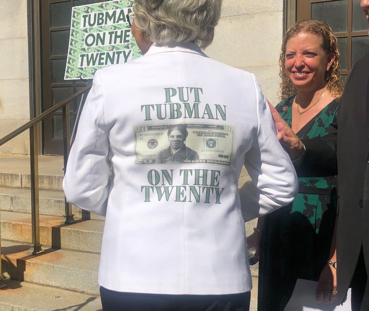 Rep. Joyce Beatty (D-Ohio) turns around to display the back of her suit jacket that says: "Put Tubman On The Twenty" with a m