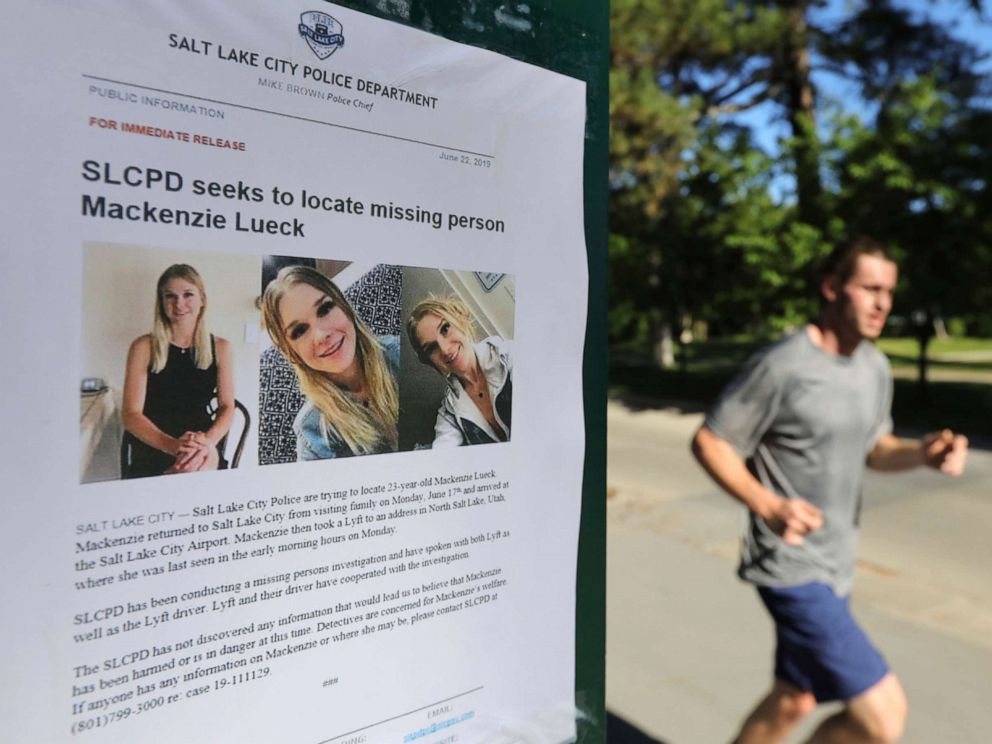 PHOTO: A jogger runs pass a poster of Mackenzie Lueck at Liberty Park in Salt Lake City, June 24, 2019.