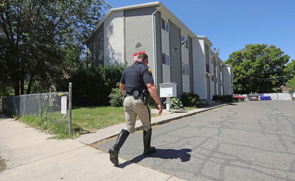 PHOTO: A police officer walks to a building where a man was taken into custody in connection with missing University of Utah student MacKenzie Lueck Friday, June 28, 2019, in Salt Lake City.