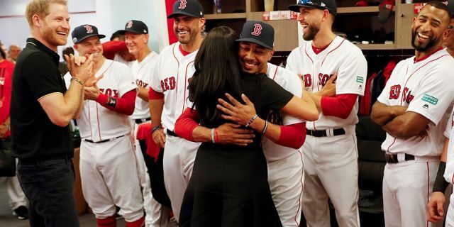 Meghan, Duchess of Sussex embraces Boston Red Sox player Mookie Betts. 