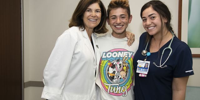 Michael Pruitt is pictured with Dr. Angel Chudler and nurse Yasmeen Bachir, who helped bring him back to life after he had no vital signs for 20 minutes. 