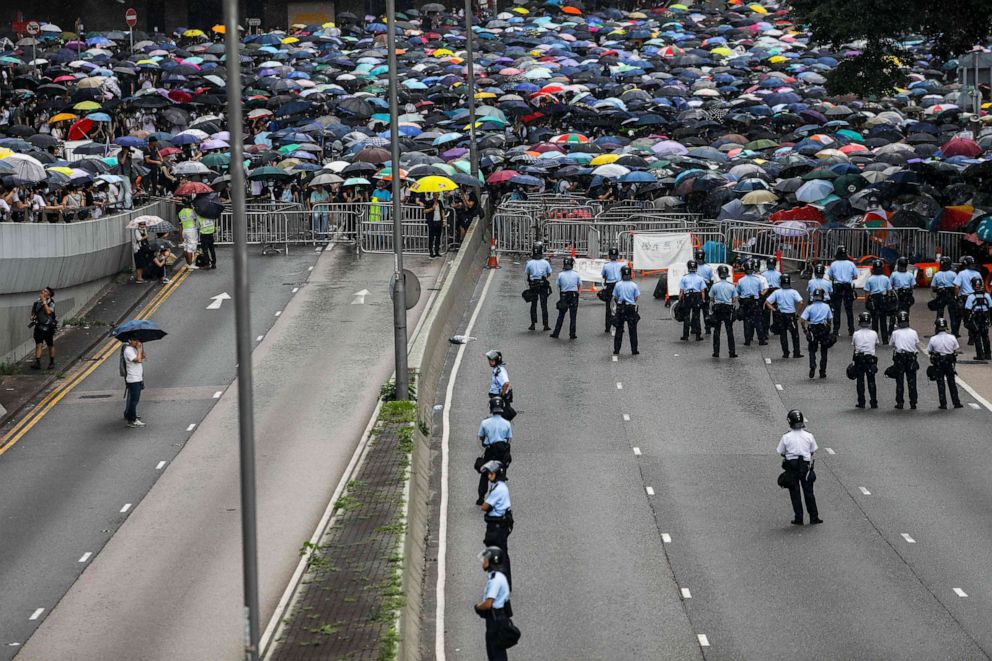 PHOTO: Police man a road as protesters attend a rally against a controversial extradition law proposal outside the government headquarters in Hong Kong, June 12, 2019. 