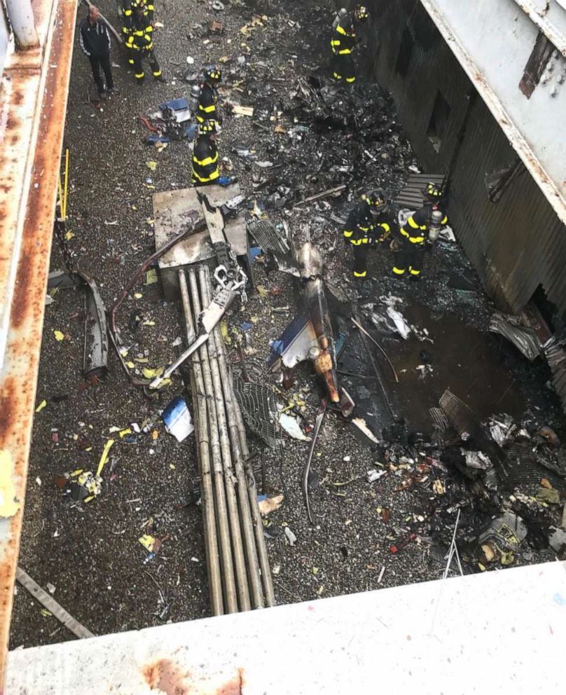 PHOTO: Firefighters at the scene of a helicopter crash at 787 7th Ave. in New York, June 10, 2019. 