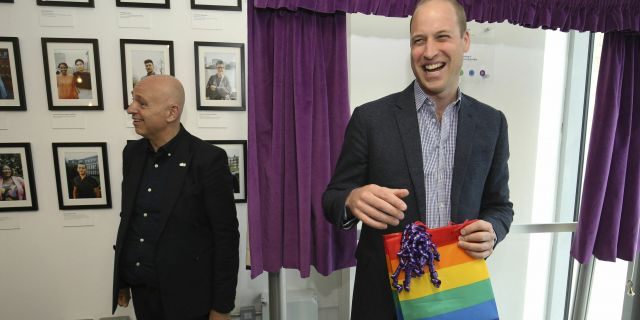 Prince William, the Duke of Cambridge, reacts to receiving a gift bag from trust chief executive officer, Tim Sigsworth, during a visit to the Albert Kennedy in London on June 26, 2019.