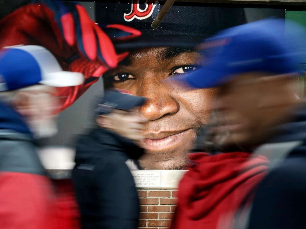PHOTO: Fans at walk past a photograph of Boston Red Soxs David Ortiz before a baseball game at Fenway Park in Boston, Oct. 1, 2016.