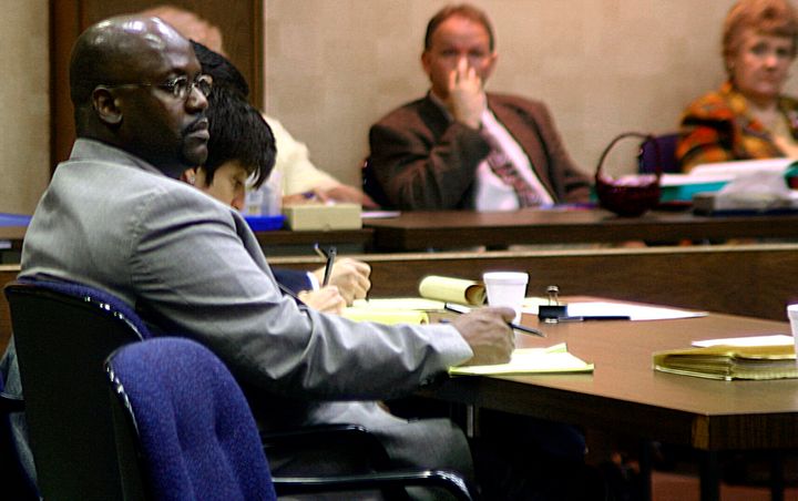 Curtis Flowers (left) listens to testimony in his third capital murder trial in Winona, Mississippi, on&nbsp;Feb. 6, 2004.