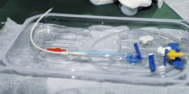 Central Venous Catheter Insertion, Some of the remaining equipment that will be used to finish the catheterization remains in the sterile pack kit, including guide wire plus tubing and the triple lumen catheter. (Getty Images)